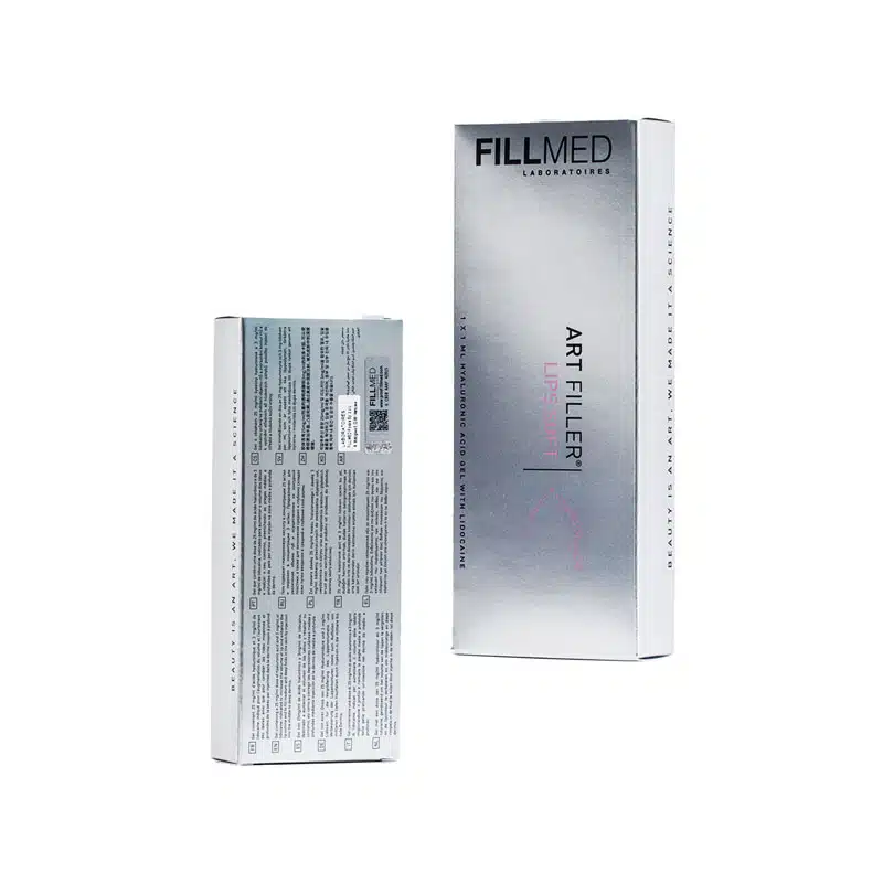 Image of a Fillmed product box with two views. The box is silver with black and pink text. The front view shows the product name "FILLMED® ART FILLER LIPS SOFT with Lidocaine" and branding, while the back view reveals text, possibly ingredients or usage instructions, and a white label.