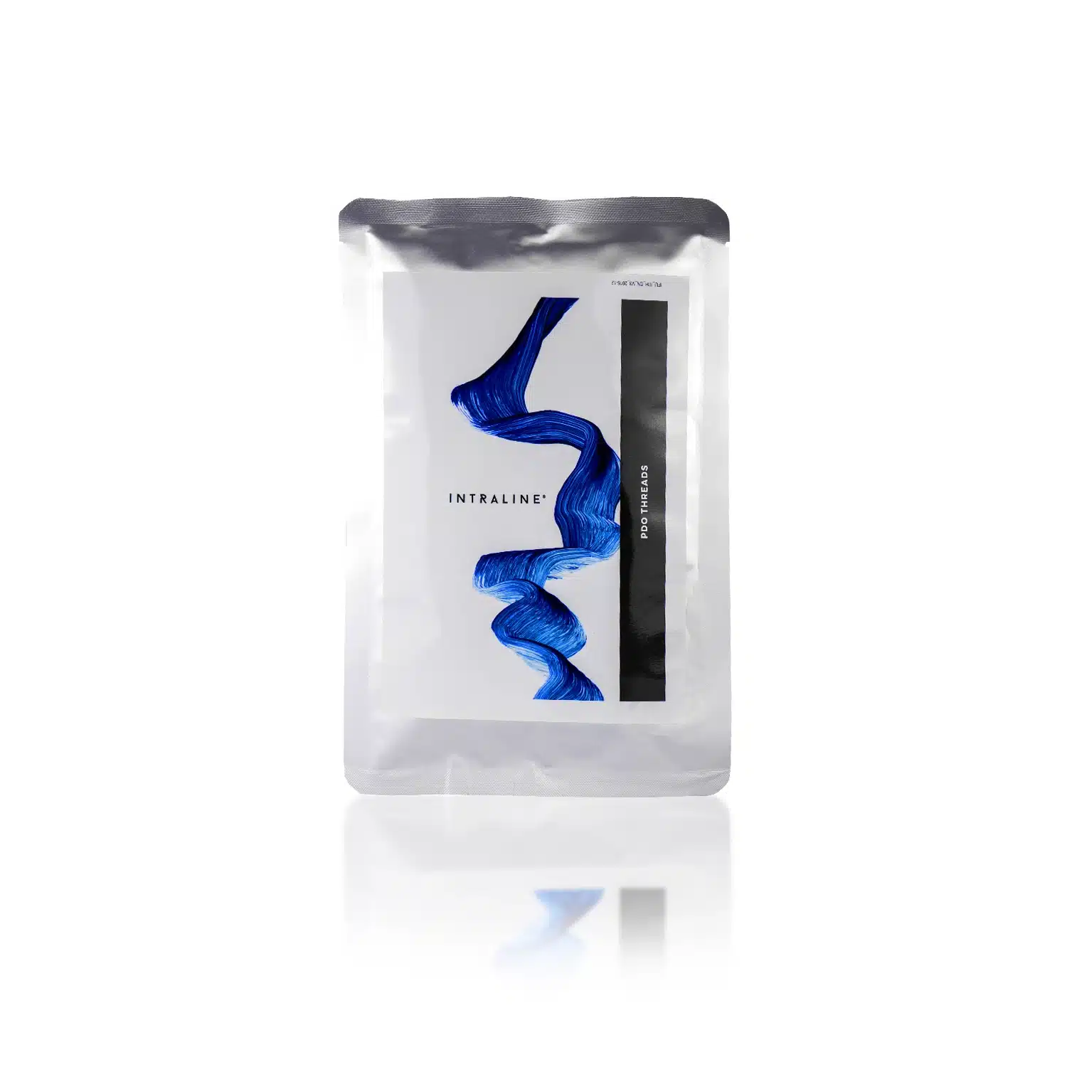 A silver rectangular packet stands upright with a white front label featuring a blue, abstract wavy design. The text "INTRALINE® COG C18100M-C Dimension 720 18G 100mm" is printed on the label, along with a black vertical stripe containing additional text. The packet has a glossy finish.