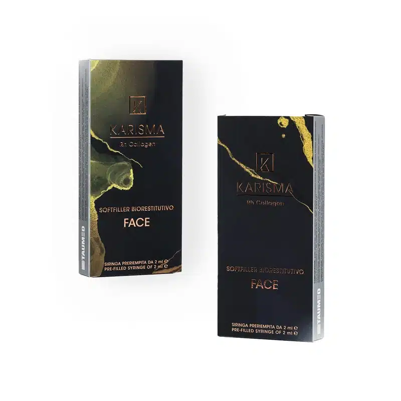 Two black and gold product boxes labeled "KARISMA RH COLLAGEN SOFTFILLER BIORESTITUTIVO FACE" with the text "Soft Filler Biorestitutivo Face." Each box has an elegant, marble-like design. Boxes display product information and contain a pre-filled syringe of 2 ml.