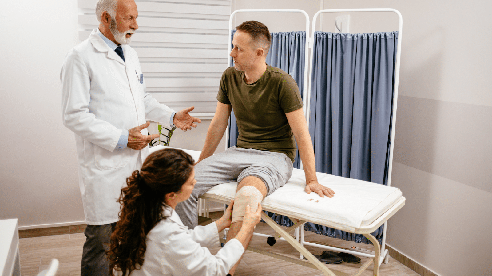 Healthcare professionals assist a male patient who just received Orthovisc injection for his knee.