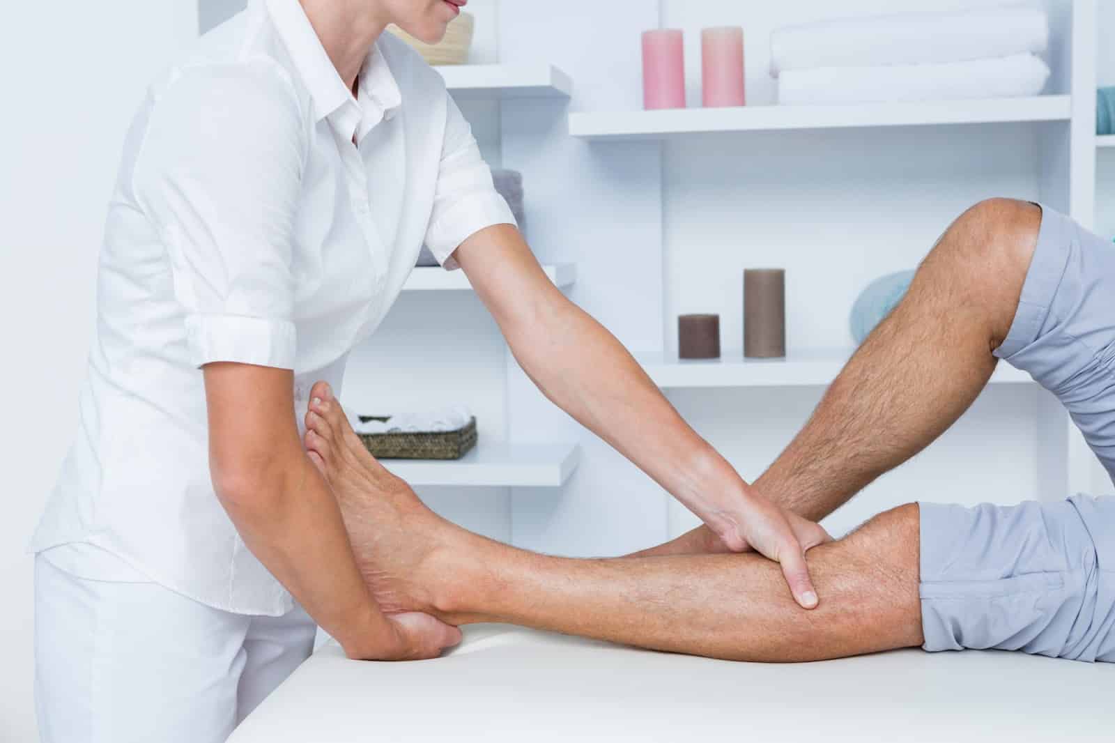 A healthcare professional carefully assessing a patient's knee before Orthovisc treatment.