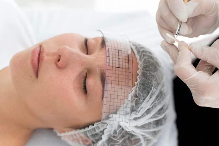 A female patient being prepared for Dysport injections.