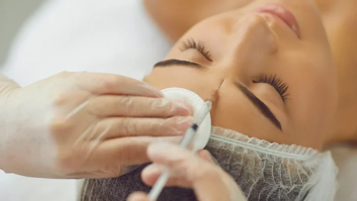 Woman getting facial injection.