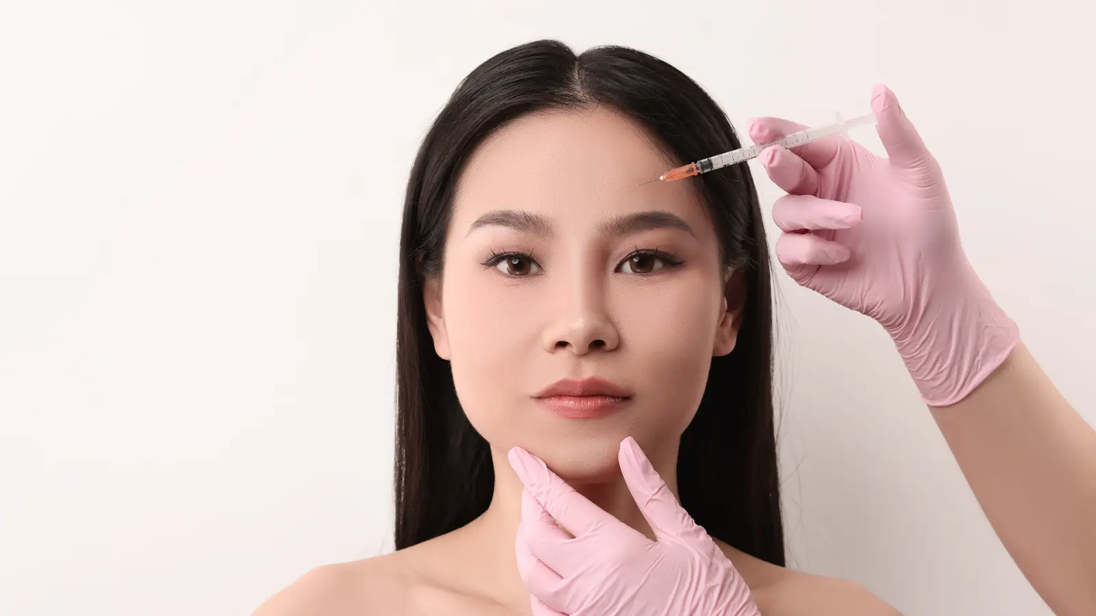 Woman getting facial injection.