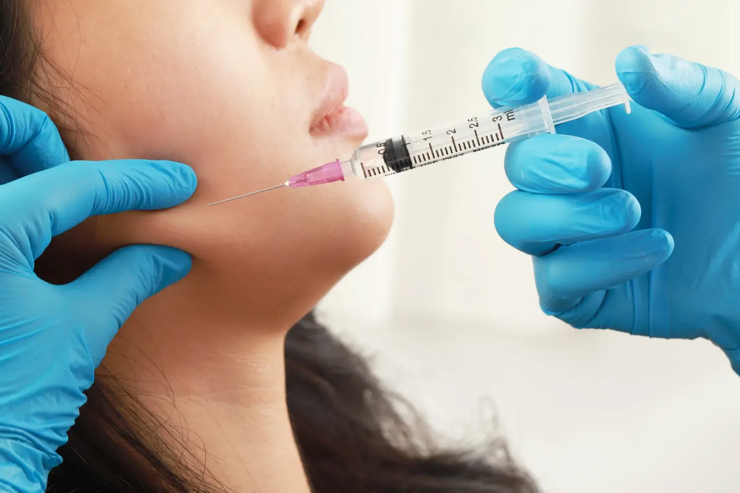 Woman getting facial injection. 