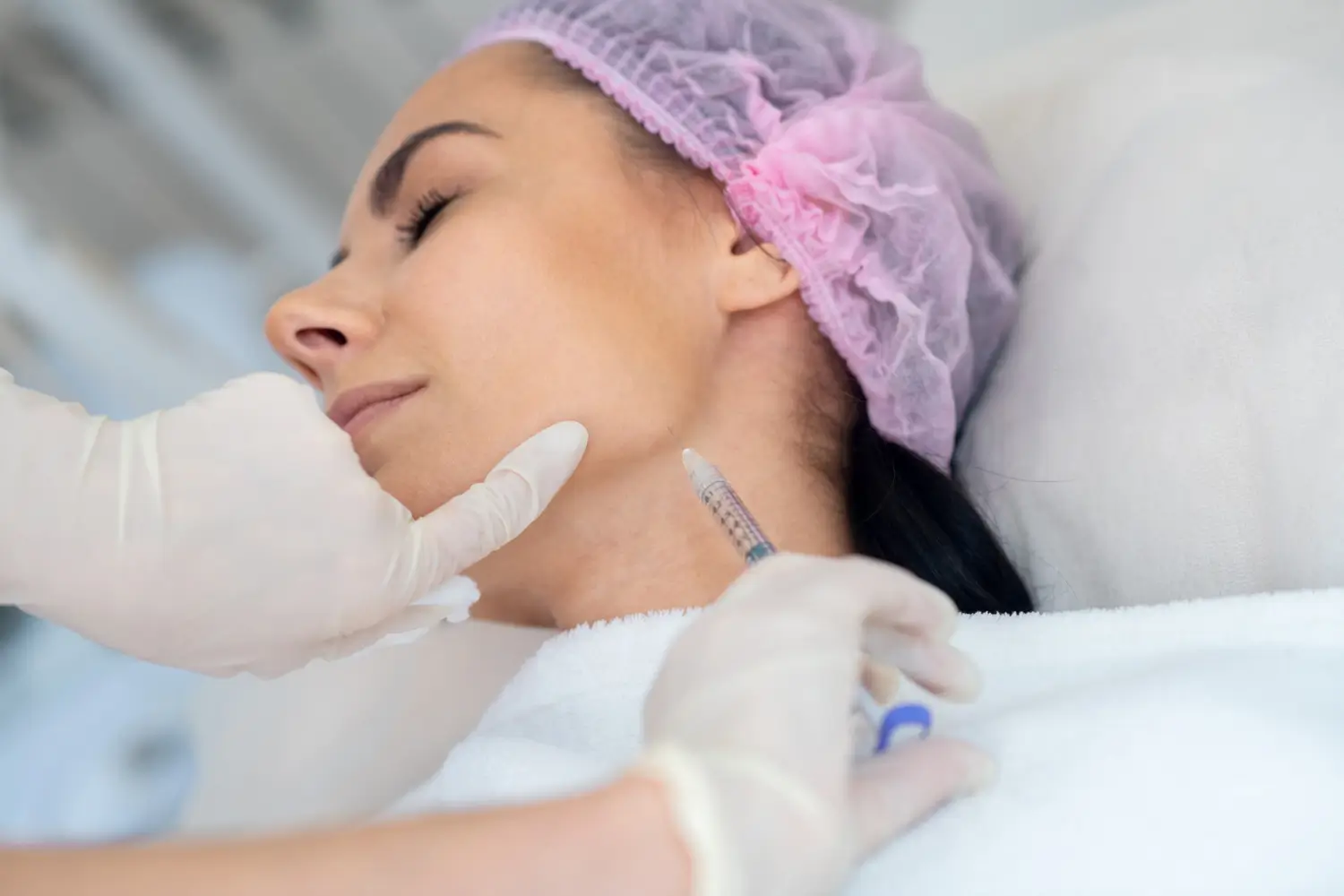 Woman getting facial injection. 