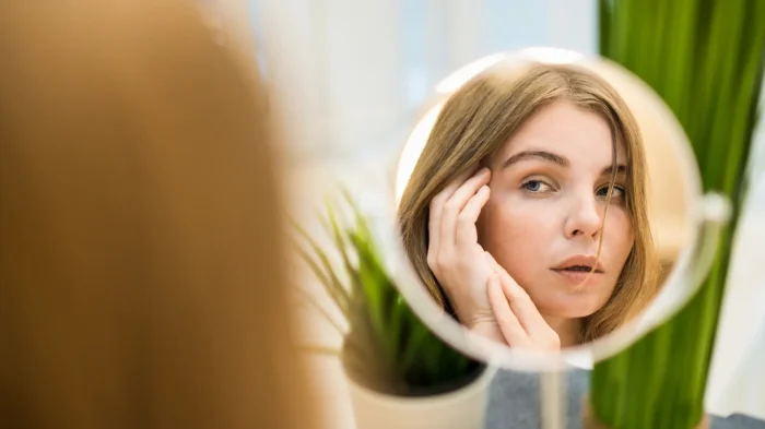 Woman looking into the mirror.