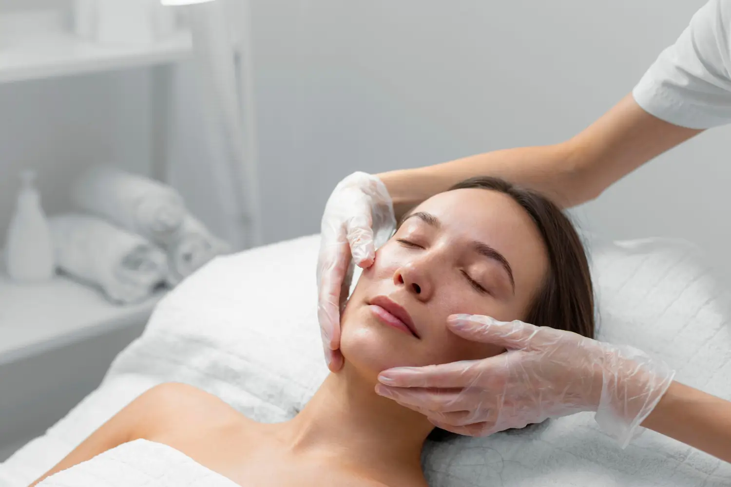 Woman getting her face massaged.