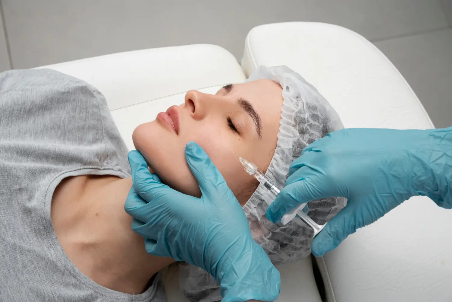 Woman getting a face injection.