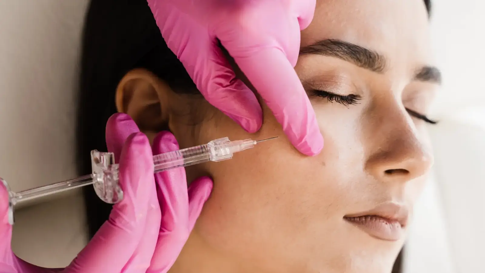 Person getting facial injections. 