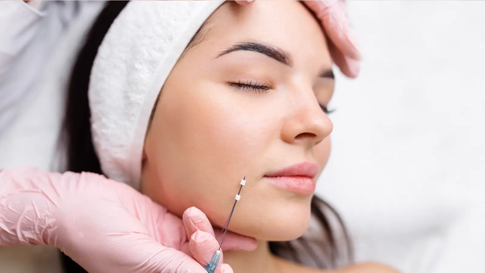 Woman's face getting threaded. 