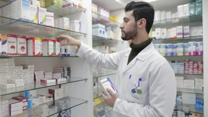 Person arranging medication.