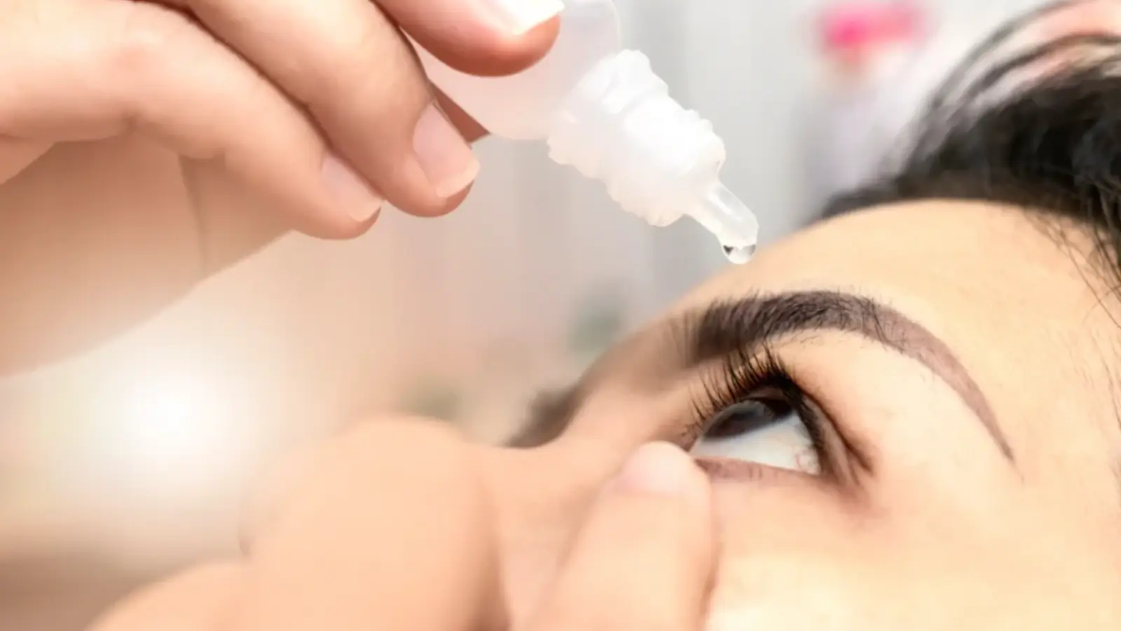 Person with eye drops. 
