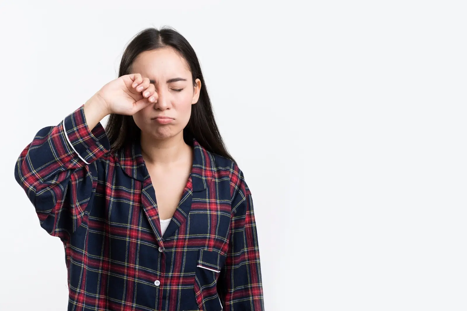 Woman rubbing her eyes.