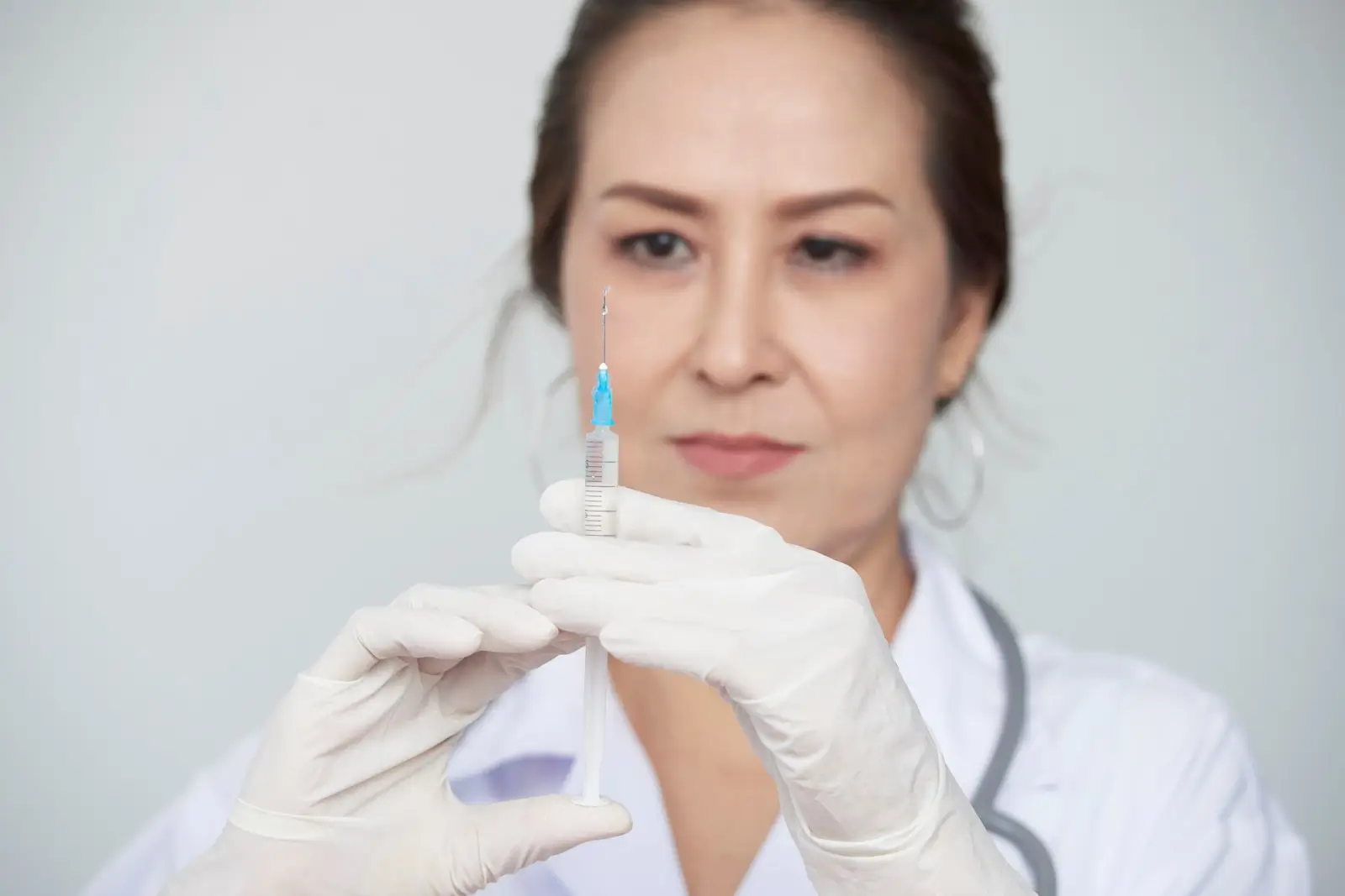 Lady preparing eye injection.