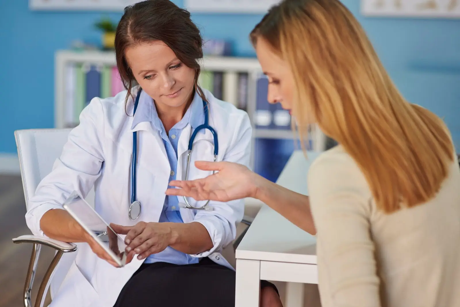 Person talking to doctor. 