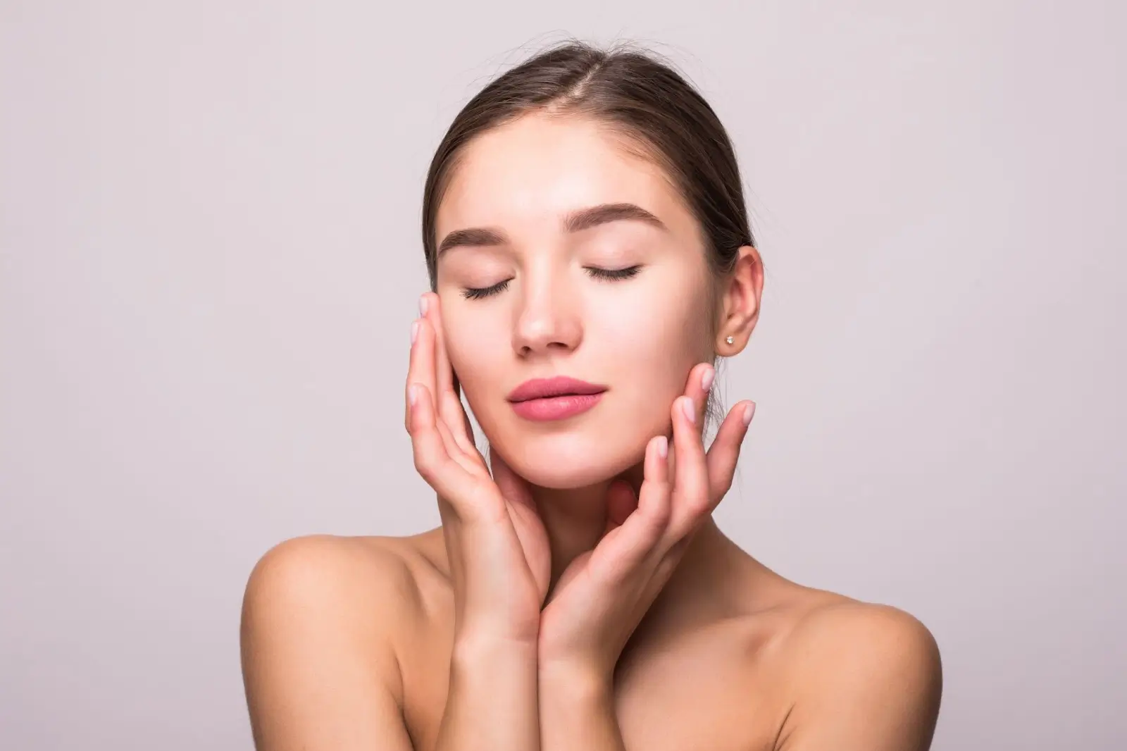Person touching her face.