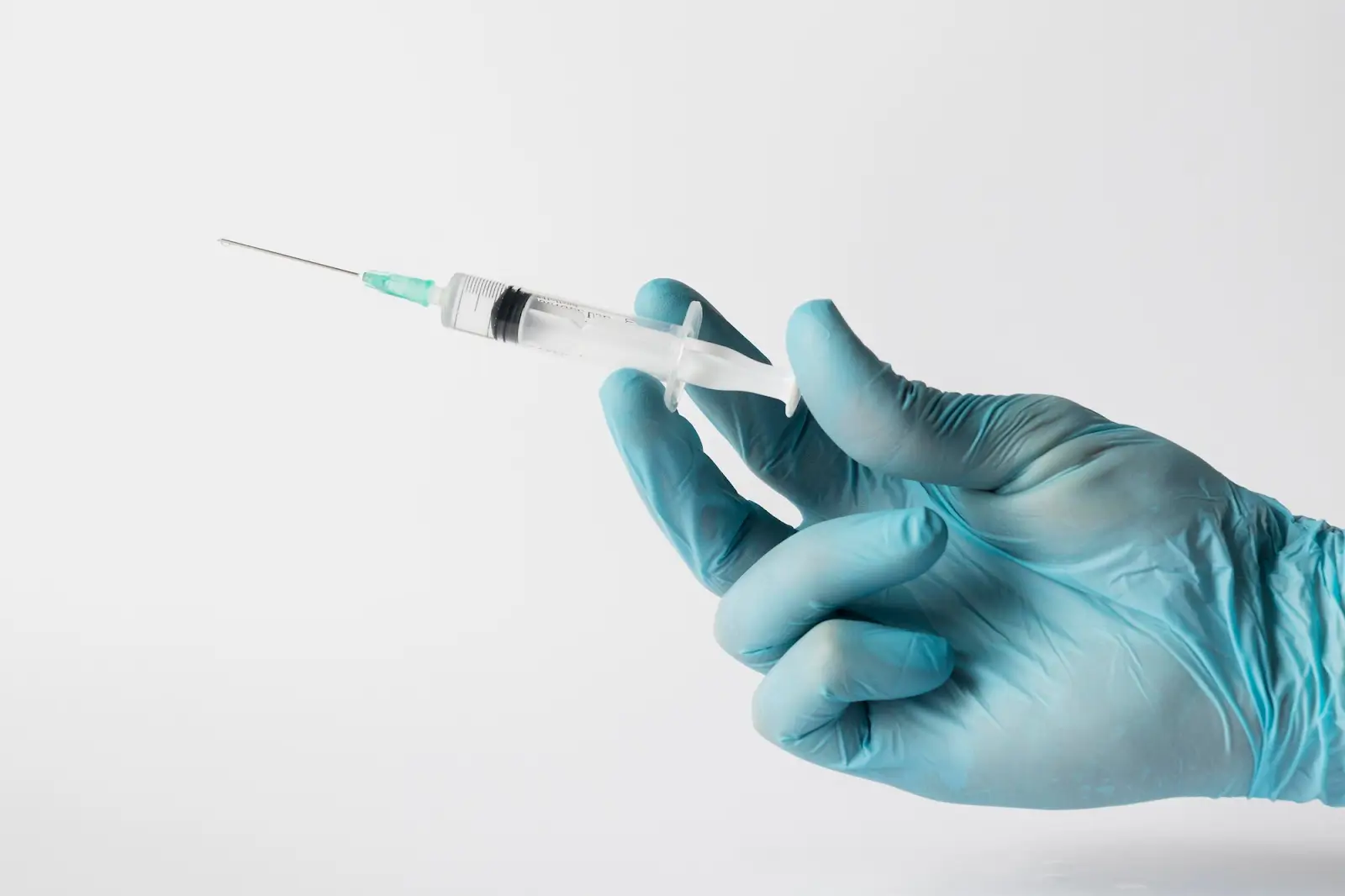 Person holding an injection. 
