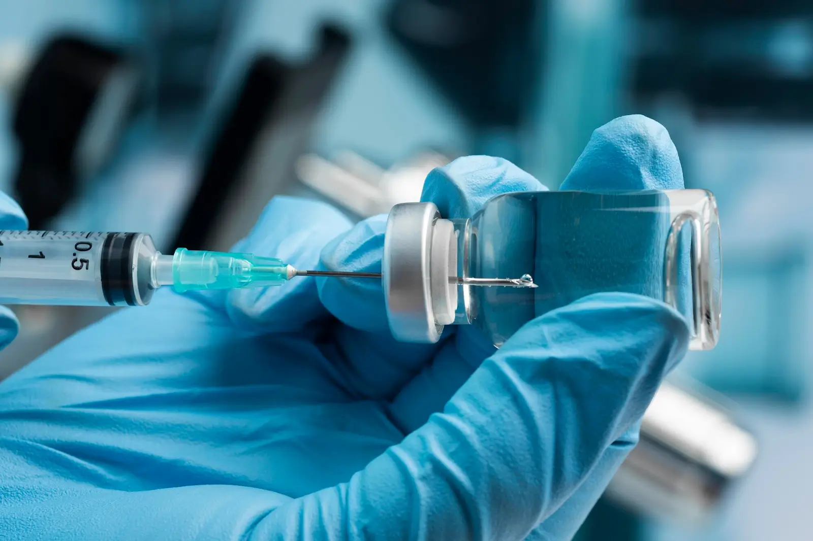Person using vial of injection. 