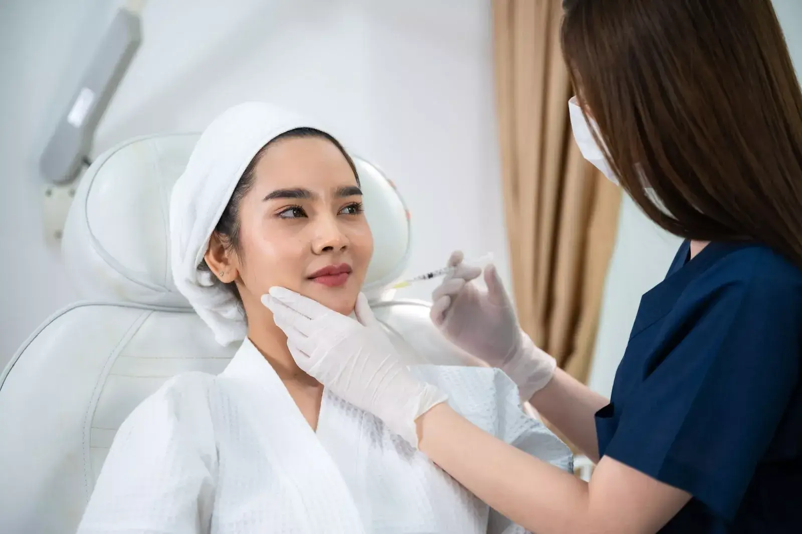 Person getting her face injected. 