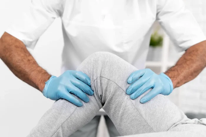 Doctor checking knee.