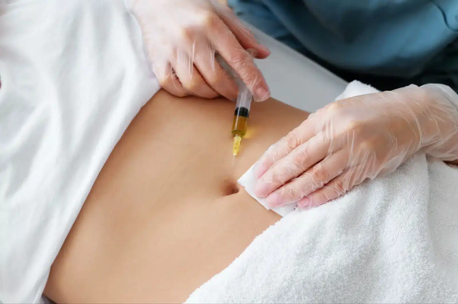 Person getting stomach injection. 