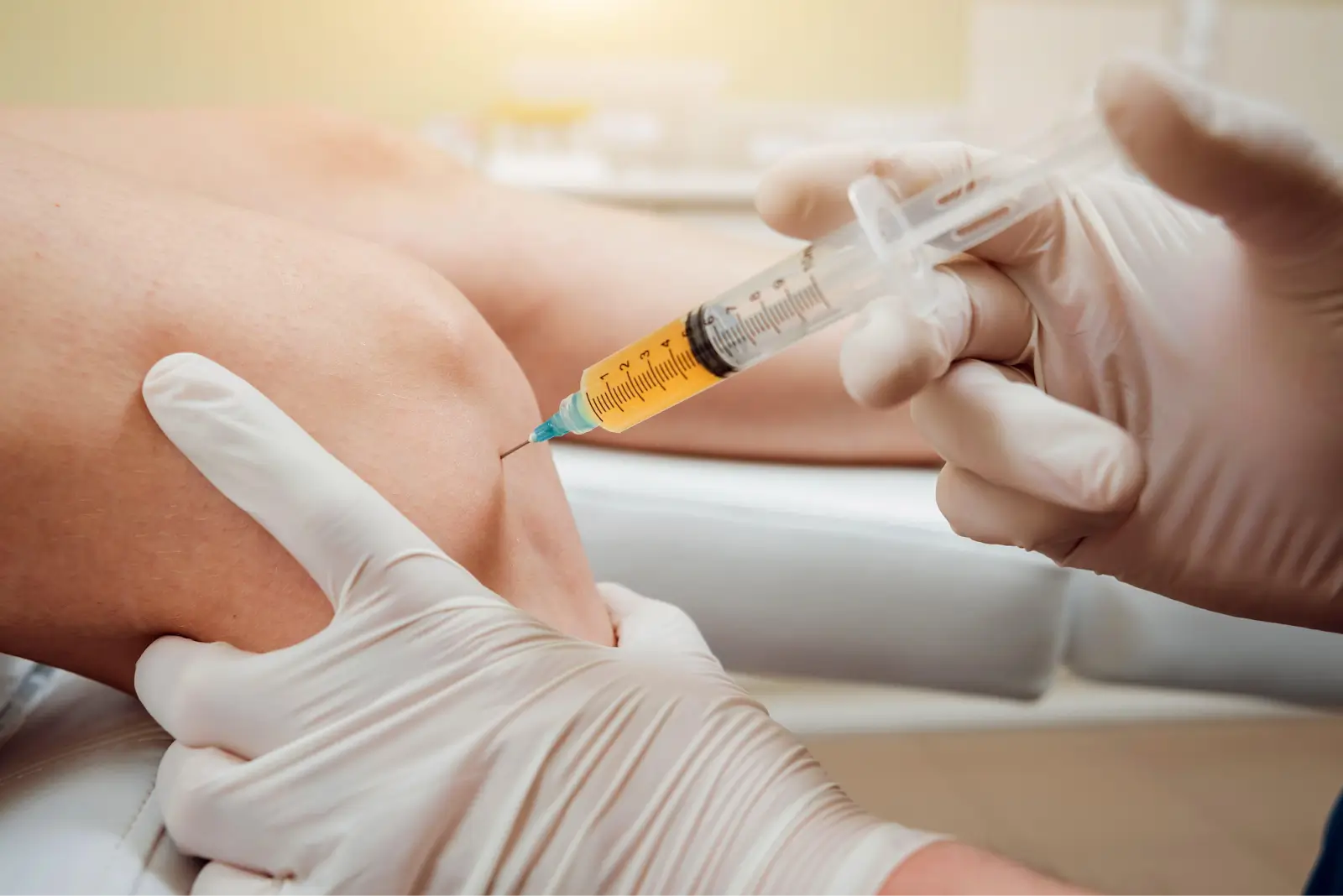 Person injecting in knee. 