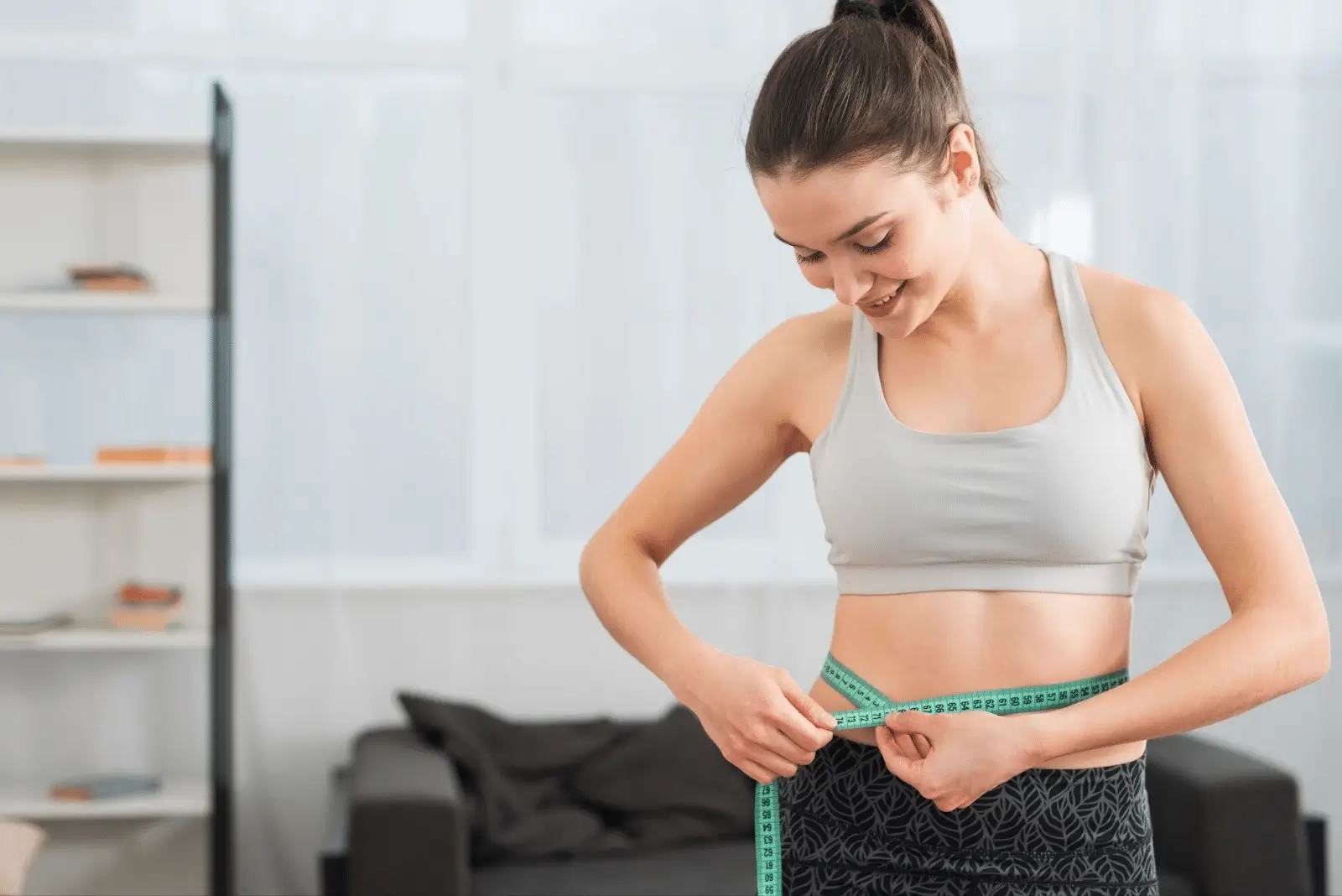 A girl measuring her waist to monitor her progress while on Mounjaro treatment.