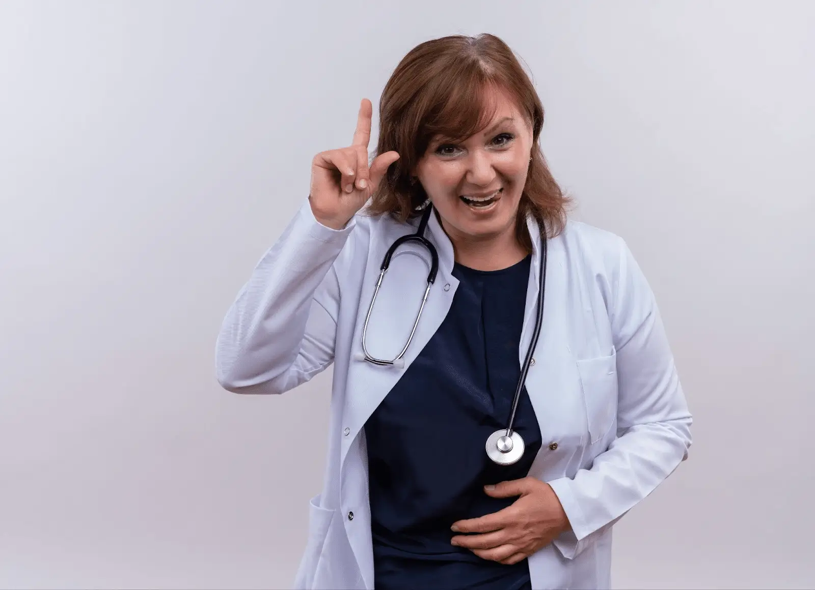 Doctor who is holding her stomach. There is a white background.