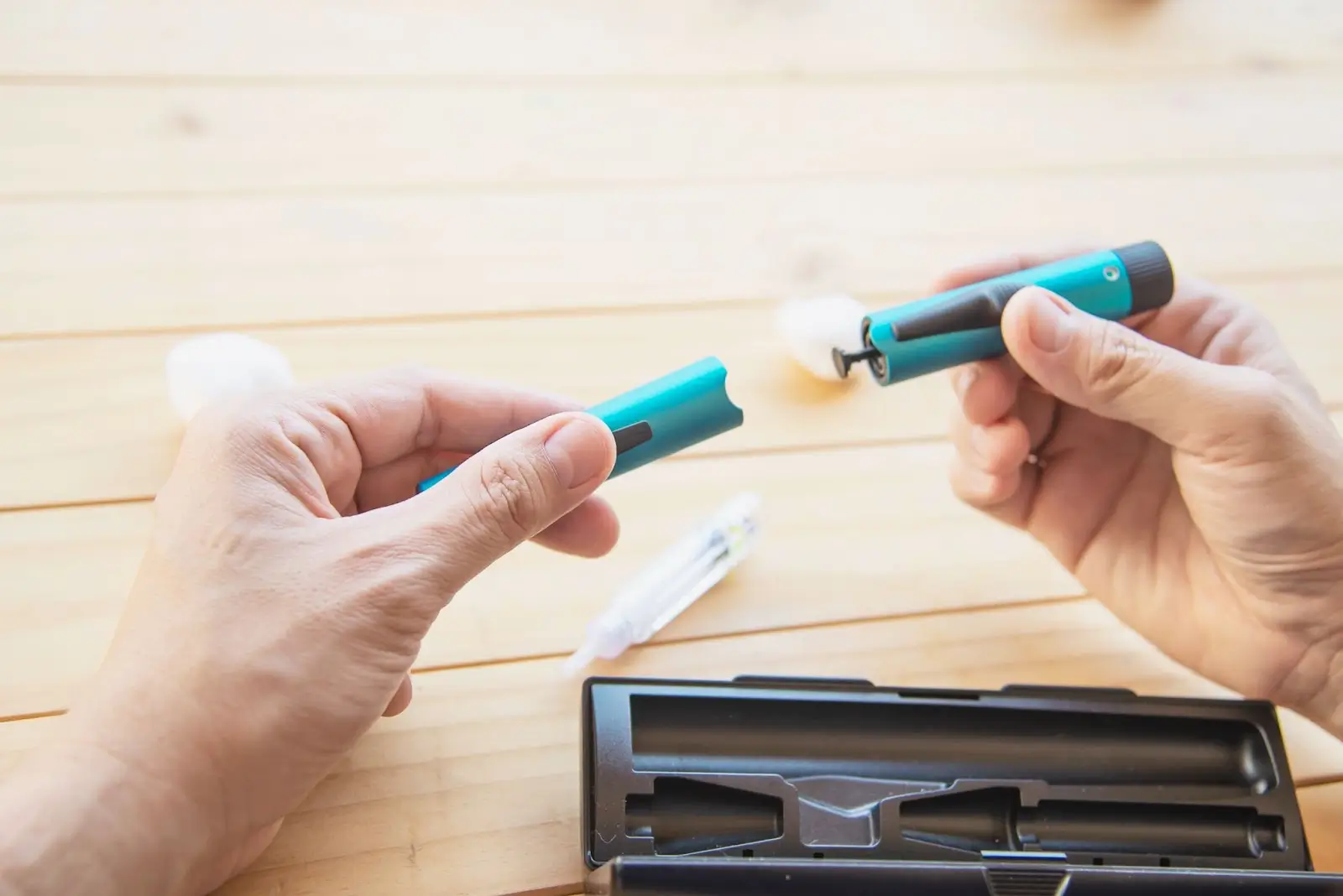 A person is holding an injection similar to Mounjaro.
