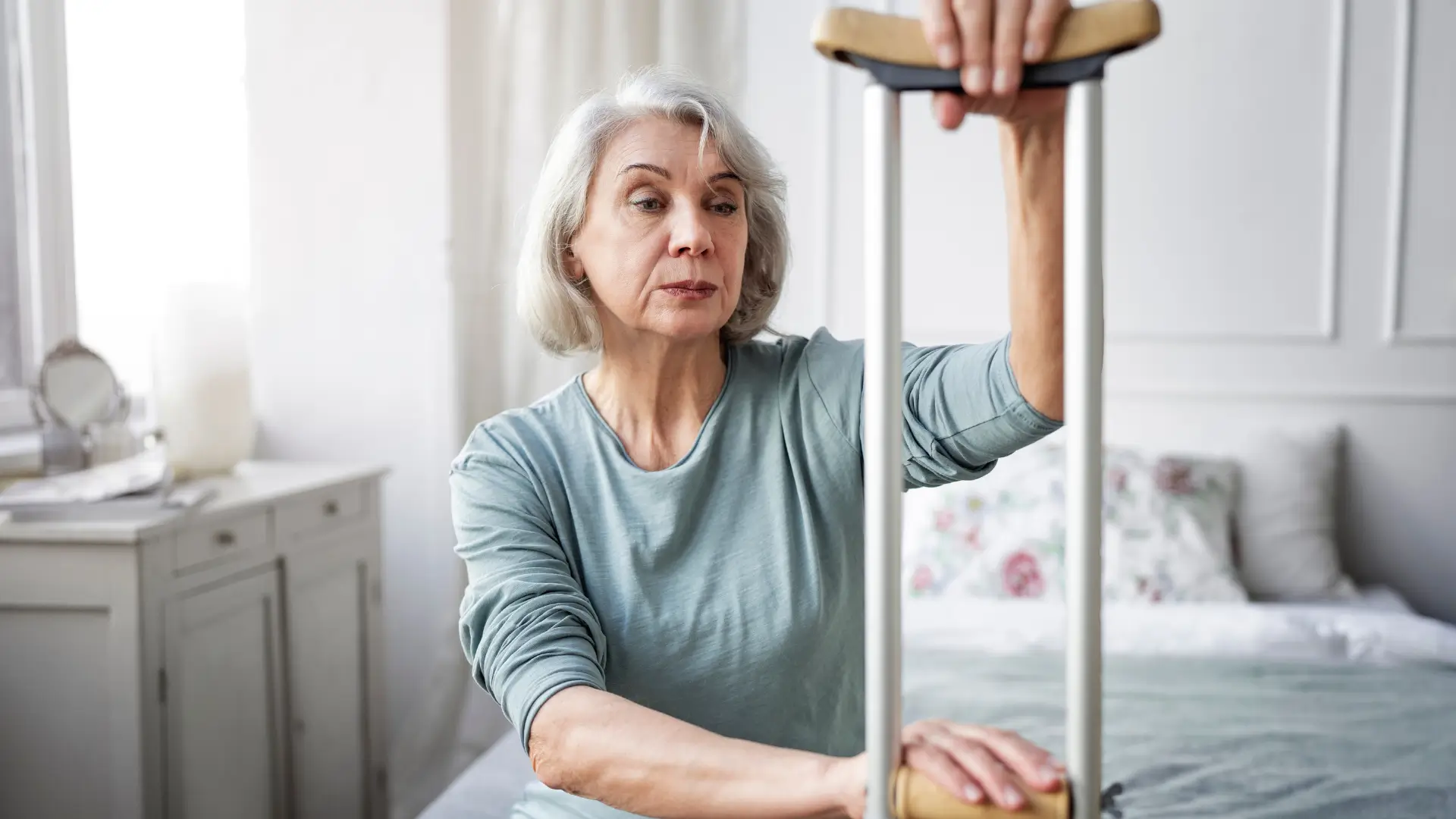 An old lady with a crutch. She is considering an Evenity treatment. 