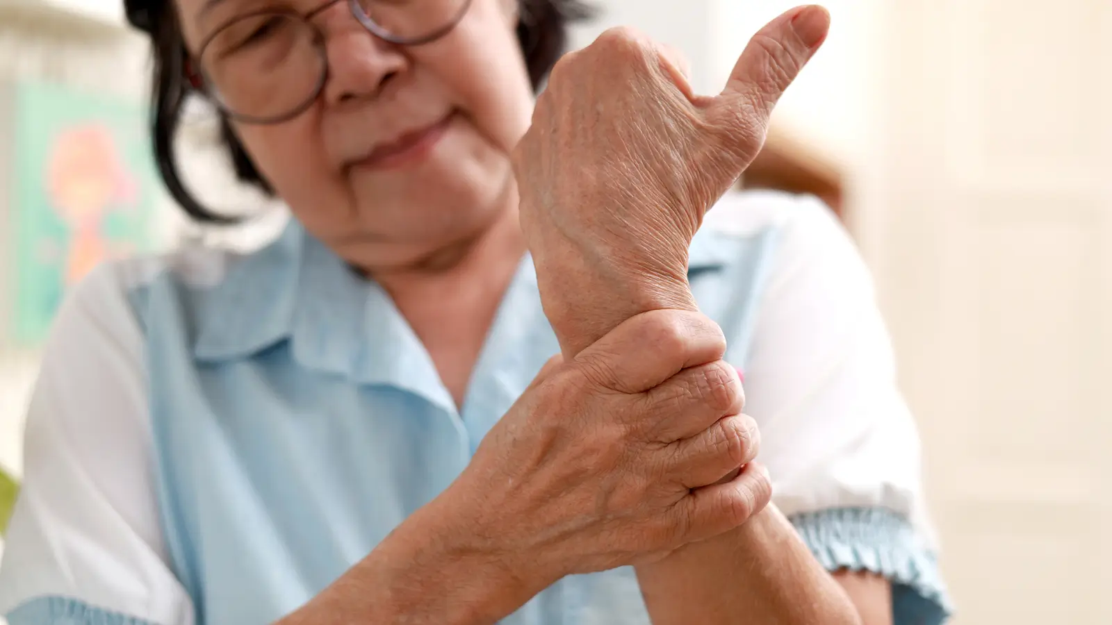 A person with hand pain. She is going for a check up to ensure eligibility for Evenity treatment.