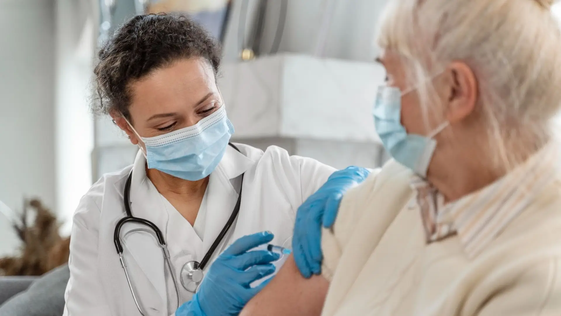 An old lady getting an Evenity injection from a healthcare professional. 