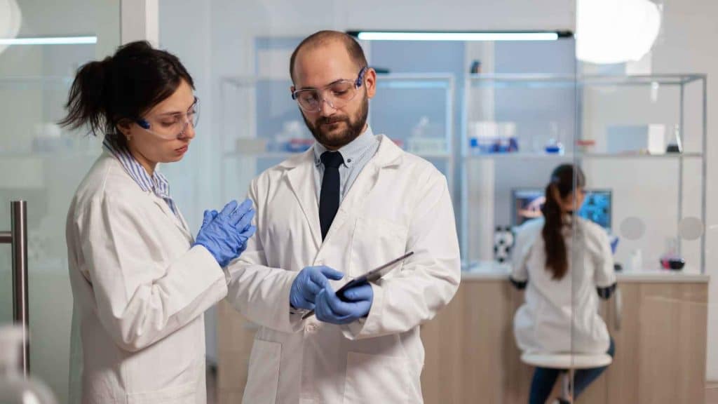 Clinical researchers evaluating Phase 3 investigational drug results in a medical research facility
