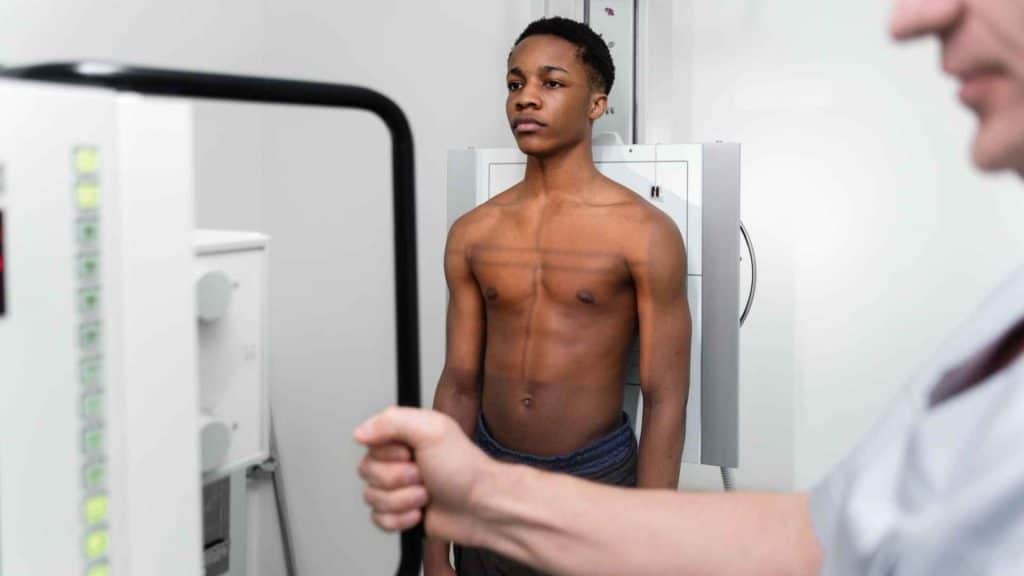 Clinician reviewing a patient’s body composition scan and weight-change data in a metabolic health clinic