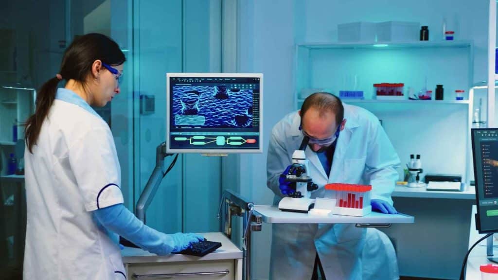 Endocrinologist comparing clinical research charts for single-, dual-, and triple-receptor agonist therapies