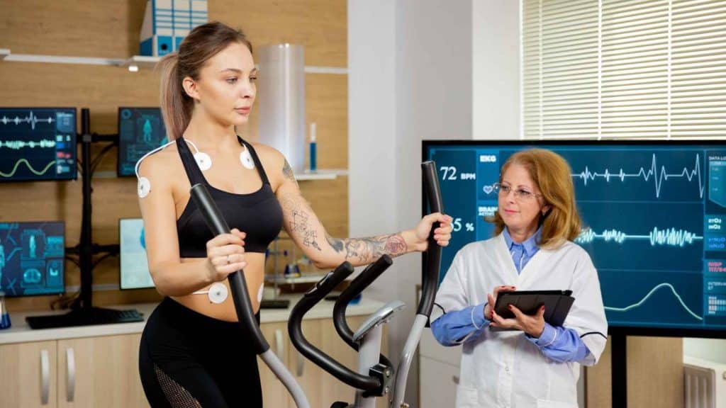 Healthcare professional assessing an adult participant’s strength and muscle function during weight-loss research