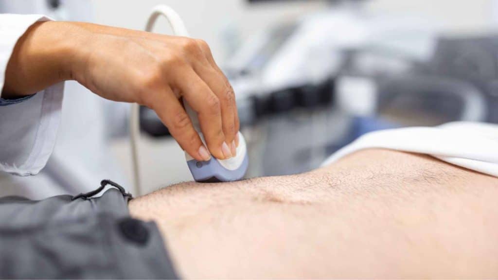 Healthcare professional performing an abdominal ultrasound during a metabolic liver assessment