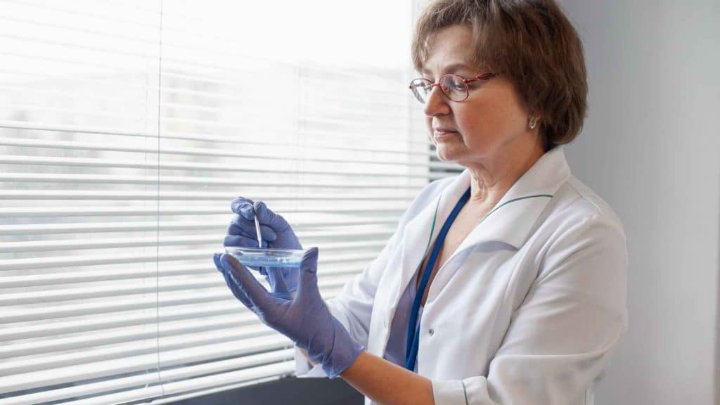 Laboratory researcher preparing an unbranded lyophilized peptide vial in a controlled workspace